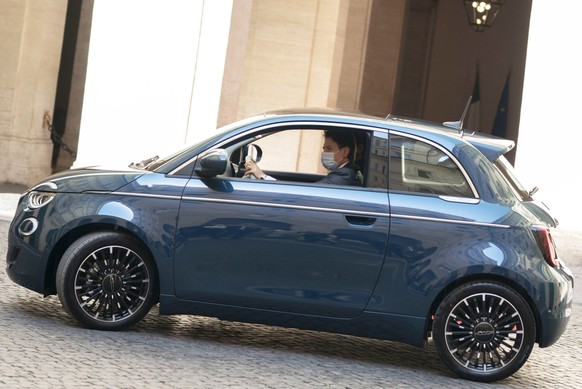 epa08525497 A handout photo made available by Chigi Palace Press Office shows Italian Prime Minister Giuseppe Conte drives the new electric Fiat 500 during its presentation in Rome, Italy, 03 July 202 ...