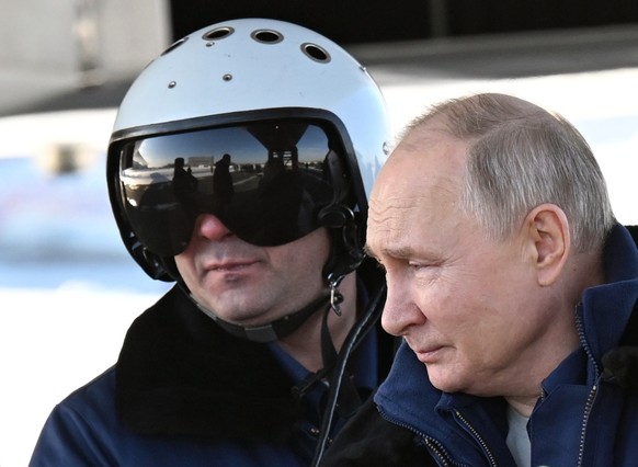 epa11172557 Russian President Vladimir Putin looks on before a test flight aboard a Tupolev Tu-160 M strategic missile carrier during a visit to the Kazan Aviation Factory named after Sergei Gorbunov, ...