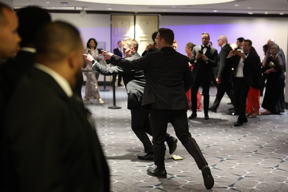 Guests exit during the White House Correspondents Dinner, Saturday, April 25, 2026, in Washington. (AP Photo/Tom Brenner)
Trump White House Correspondents Dinner
