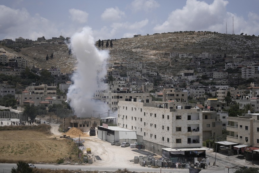 FILE - Smoke rises during fighting between Israeli forces and Palestinian militants in the West Bank city of Jenin, Monday, June 19, 2023. The death of a 15-year-old girl who was killed by suspected I ...