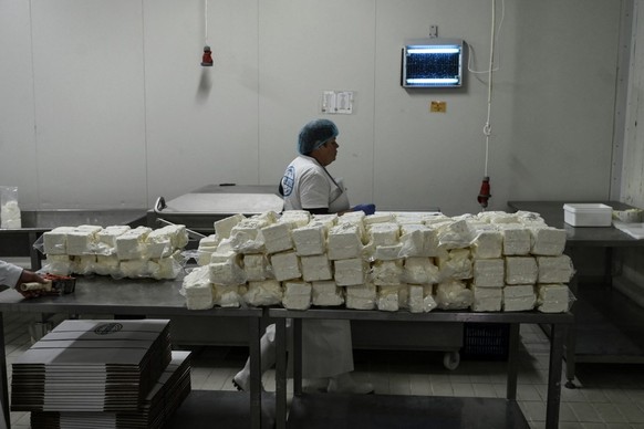 An employee works in a feta factory in Thessaloniki on February 19, 2026. From August 2024 to early March 2026, more than 480,000 sheep and goats have been slaughtered because of the pandemic, mainly  ...