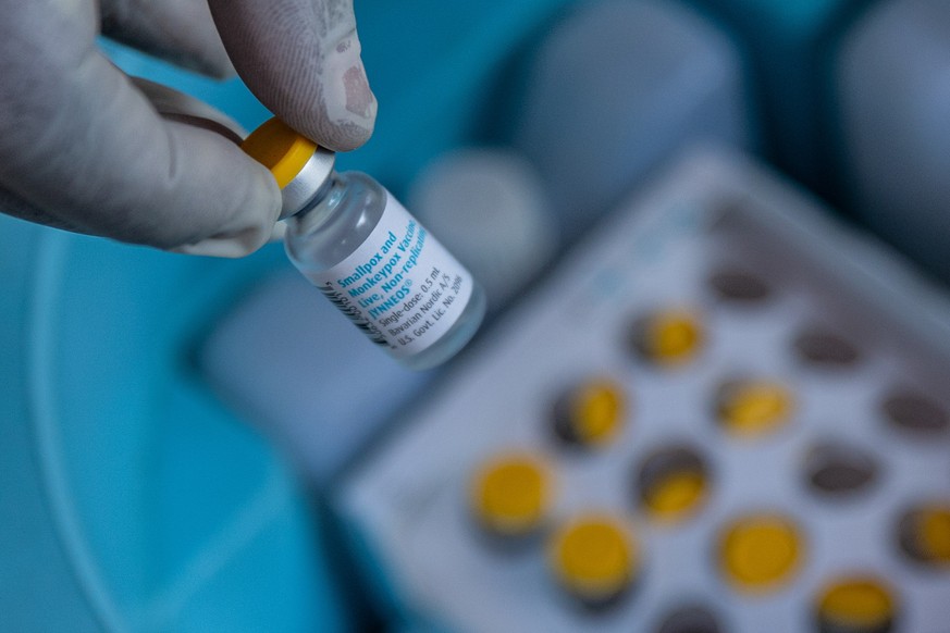 epa11644020 A medical staff displays a vial containing a vaccine for smallpox and mpox made by Danish drugmaker Bavarian Nordic in a symbolic start of the mpox vaccination campaign at Goma General Hos ...