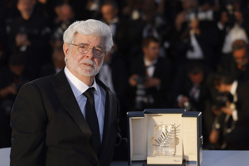 George Lucas poses with the honorary Palme d'Or during the photo call following the awards ceremony at the 77th international film festival, Cannes, southern France, Saturday, May 25, 2024. (Phot ...