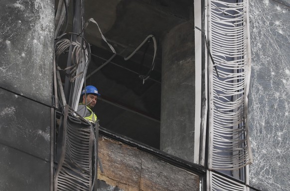 epa10814857 A worker inside a damaged building in the Moscow-City business center after a drone reportedly fell, in Moscow, Russia, 23 August 2023. The Russian Defence Ministry reported that the air d ...
