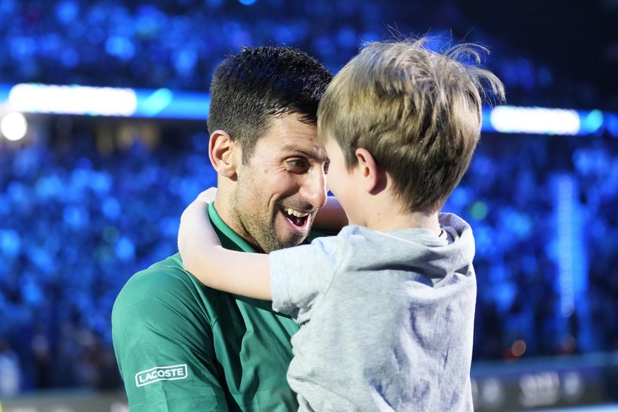 Serbia&#039;s Novak Djokovic celebrates with his son after defeating Norway&#039;s Casper Ruud 7-5, 6-3, in their singles final tennis match of the ATP World Tour Finals at the Pala Alpitour, in Turin ...