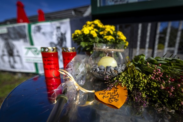 epa13204264 Flowers, candles, and a handwritten note reading 'Stay strong, everyone' are placed outside the entrance to the Schachen horse racing track in Aarau, Switzerland, 01 September 20 ...
