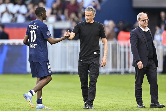 PARIS, FRANCE - APRIL 6: Ousmane Dembele of Paris Saint Germain (L) celebrates with PSG Head Coach Luis Enrique (C) after winning Ligue 1 McDonald&#039;s 2024/25 title during the France Ligue 1 match  ...