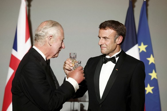 epa10872898 French President Emmanuel Macron (R) and Britain's King Charles III attend a state dinner in the Hall of Mirrors at the Palace of Versailles, in Versailles, near Paris, France, 20 Sep ...