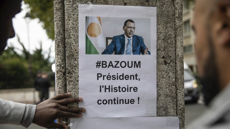 Demonstrators gather in front of the Embassy of Niger in Paris, in support of Nigerien President Mohamed Bazoum and ECOWAS, Saturday, Aug. 5, 2023. (AP Photo/Sophie Garcia)