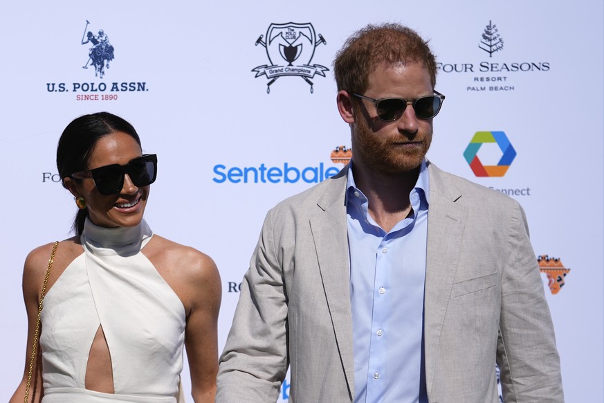 FILE - Britain&#039;s Prince Harry, right, and wife Meghan Markle, Duchess of Sussex, arrive for the 2024 Royal Salute Polo Challenge to Benefit Sentebale, on April 12, 2024, in Wellington, Fla. Princ ...