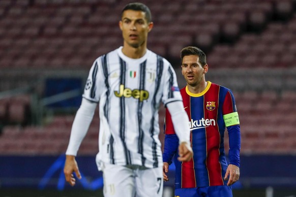 Barcelona's Lionel Messi, right, and Juventus' Cristiano Ronaldo during the Champions League group G soccer match between FC Barcelona and Juventus at the Camp Nou stadium in Barcelona, Spain, Tuesday ...