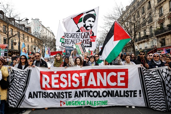 epa11981833 People holding a banner saying &#039;Resistance&#039; attend a nationwide demonstration against racism and fascism marking International Day Against Racism and Discrimination in Paris, Fra ...