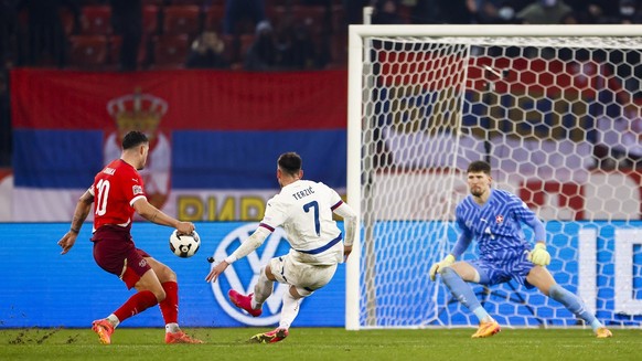 Serbia&#039;s Aleksa Terzic, center, scores the 1:1 goal to Switzerland&#039;s goalkeeper Gregor Kobel, right, next to Switzerland&#039;s midfielder Granit Xhaka, left, during the UEFA Nations League  ...