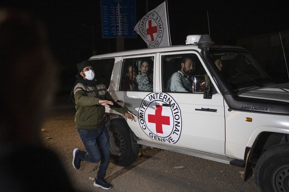 FILE - A Red Cross vehicle carrying Israeli hostages drives by at the Gaza Strip crossing into Egypt in Rafah on Nov. 25, 2023. (AP Photo/Fatima Shbair, File)