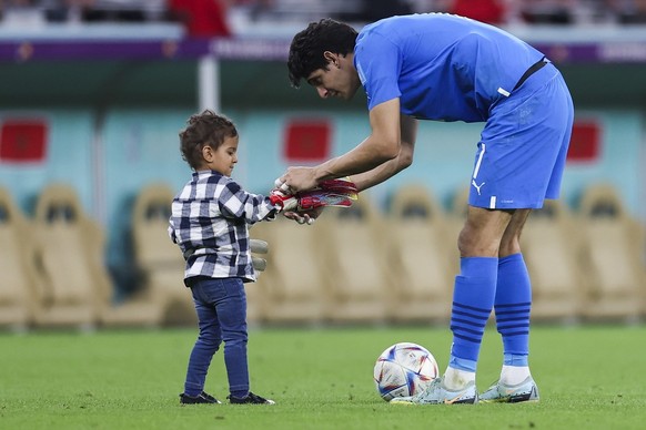epa10359759 Morocco goalkeepr Yassine Bounou plays with his son after the FIFA World Cup 2022 quarter final soccer match between Morocco and Portugal at Al Thumama Stadium in Doha, Qatar, 10 December  ...