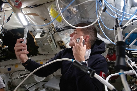In this photo provided by NASA, Artemis II mission specialist and CSA (Canadian Space Agency) astronaut Jeremy Hansen enjoys a shave inside the Orion spacecraft during Flight Day 5 and ahead of the cr ...