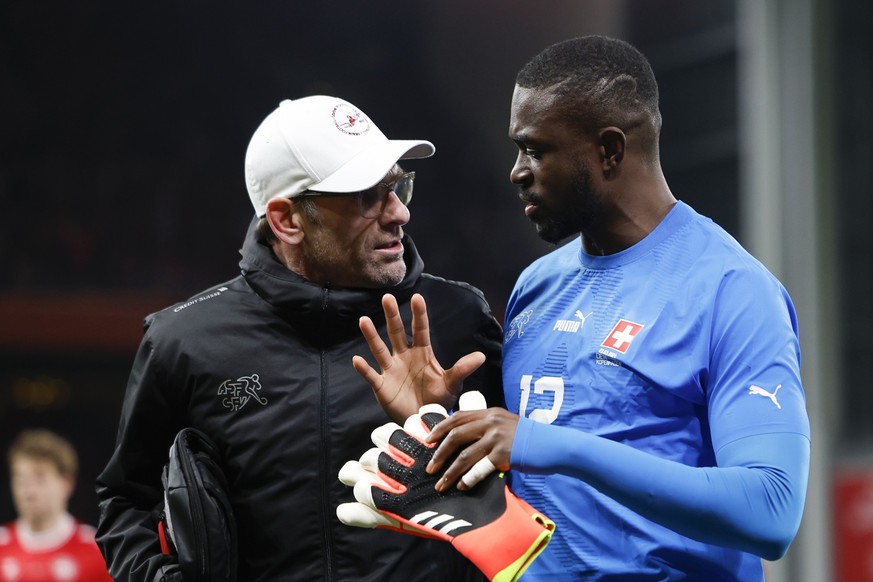 Switzerland's goalkeeper Yvon Mvogo, right, talks to goalkeeper coach Patrick Foletti during halftime in the friendly soccer match between Denmark and Switzerland at the Parken stadium in Copenha ...