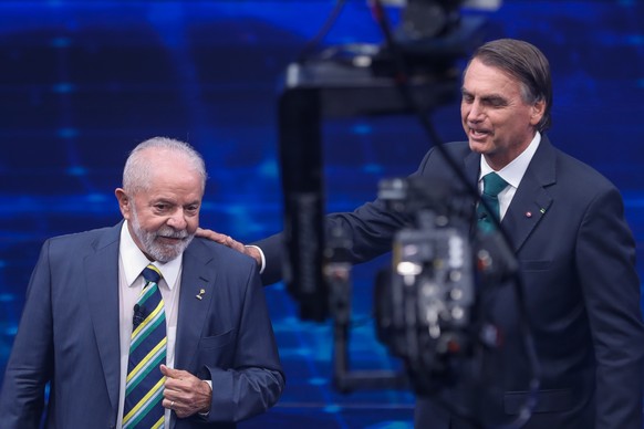 Brazil&#039;s former President Luiz Inacio Lula da Silva, who is running for office again, left, faces Jair Bolsonaro in a presidential debate at Bandeirantes Television in Sao Paulo, Brazil, Sunday,  ...