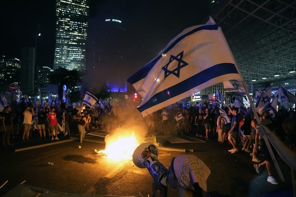 Demonstrators protest against plans by Prime Minister Benjamin Netanyahu&#039;s government to overhaul the judicial system, in Tel Aviv, Monday, July 24, 2023. Israeli lawmakers on Monday approved a k ...