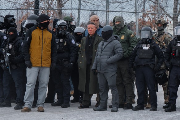 epa12653483 US Border Patrol Chief Patrol Agent Gregory Bovino (C) stands among Minneapolis Police Department and federal agents during an anti-ICE protest outside the Whipple Federal Building, a base ...