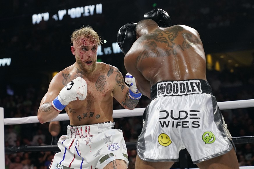 FILE - Jake Paul, left, punches Tyron Woodley during the second round of a Cruiserweight fight on Dec. 19, 2021, in Tampa, Fla. YouTube sensation Paul will take on former UFC veteran Nick Diaz in a bo ...