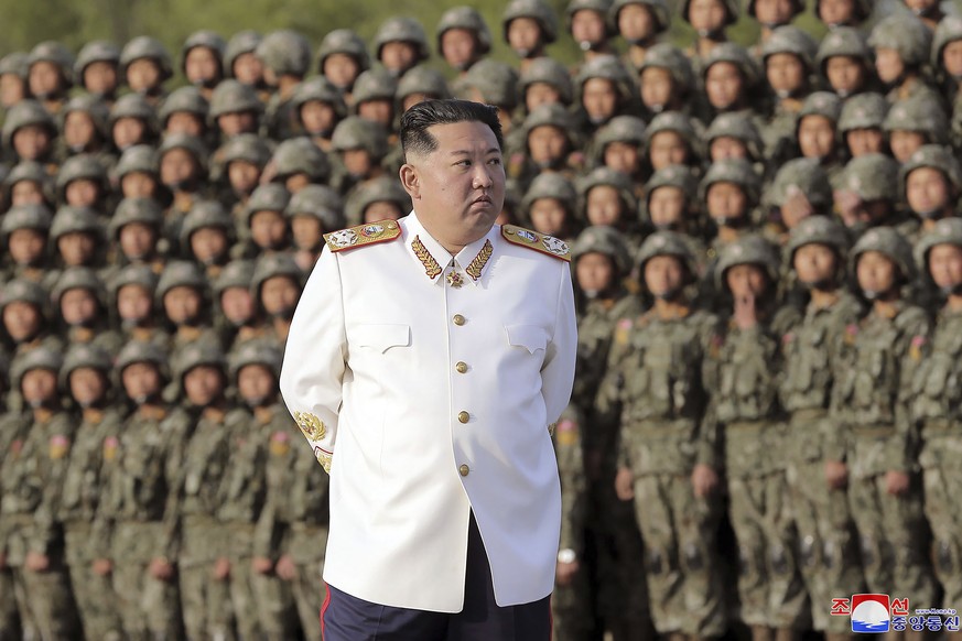 FILE - In this photo provided by the North Korean government, North Korean leader Kim Jong Un attends a photo session with the officers and soldiers who took part in a celebration the 90th founding an ...
