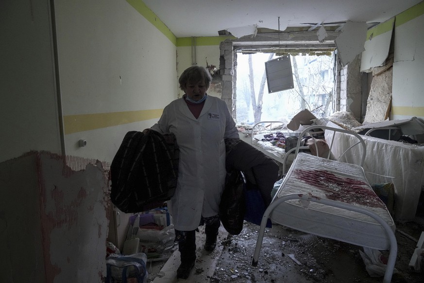 A medical worker walks inside of the damaged by shelling maternity hospital in Mariupol, Ukraine, Wednesday, March 9, 2022. A Russian attack has severely damaged a maternity hospital in the besieged p ...