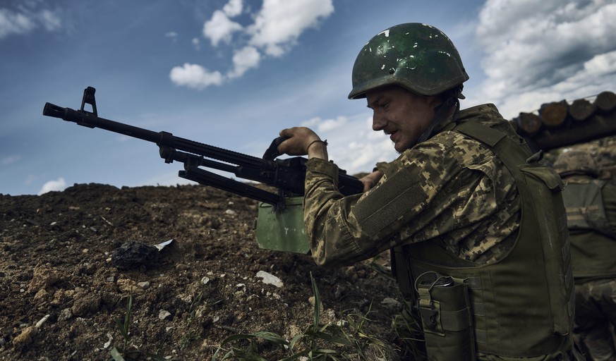 A Ukrainian soldier is seen in a trench at the frontline near Bakhmut in the Donetsk region, Ukraine, Monday, May 22, 2023. (AP Photo/Libkos)