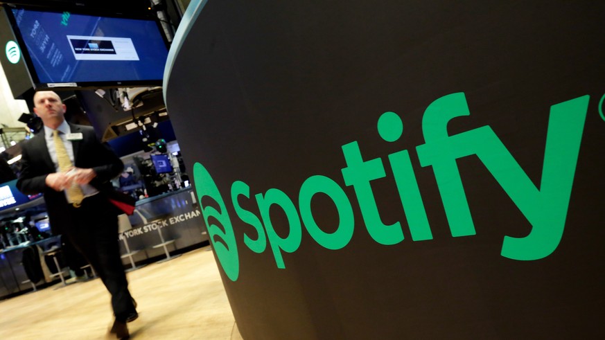 FILE - A trading post sports the Spotify logo on the floor of the New York Stock Exchange, Tuesday, April 3, 2018. Spotify said Monday, Dec. 4, 2023 it&#039;s axing 17% of its global workforce, in the ...