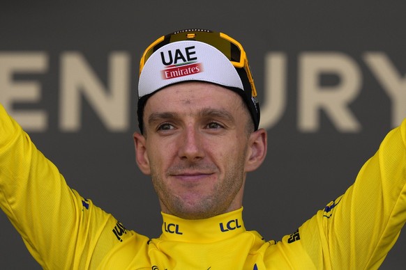 Britain&#039;s Adam Yates wearing the overall leader&#039;s yellow jersey, celebrates on the podium of the first stage of the Tour de France cycling race over 182 kilometers (113 miles) with start and ...