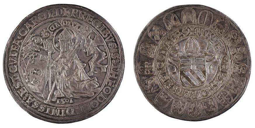 Thaler de l’évêché de Sion datant de 1501. Une face représente Saint Théodule; l’autre, les armoiries de la famille Schiner ornées d’une crosse, d’une mitre et d’un glaive.