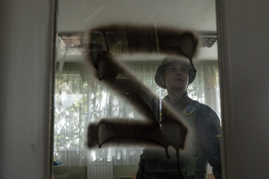 A Ukrainian serviceman inspects a kindergarten classroom with a sign &quot;Z&quot; on the door that was used by Russian forces in the recently retaken area of Kapitolivka, Ukraine, Sunday, Sept. 25, 2 ...