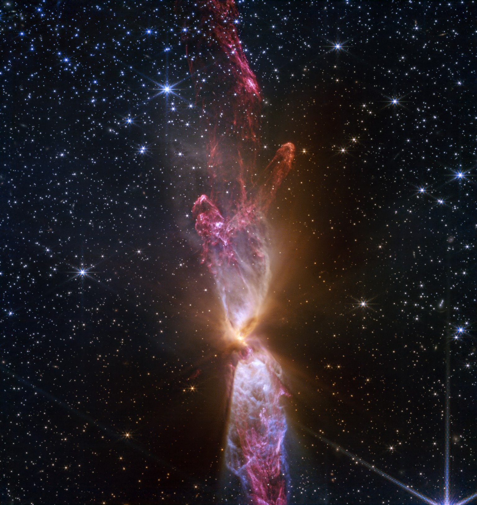 Like Sands Through the Hourglass…
Two actively forming stars are responsible for the shimmering hourglass-shaped ejections of gas and dust that gleam in orange, blue, and purple in this representative ...