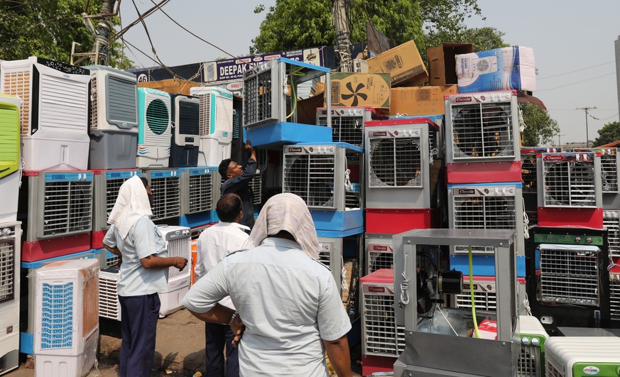 epa09914259 An Indian worker displays air coolers for sale as the temperature rises in New Delhi, 28 April 2022. According to the Indian Meteorological Department (IMD), Delhi and the National Capital ...