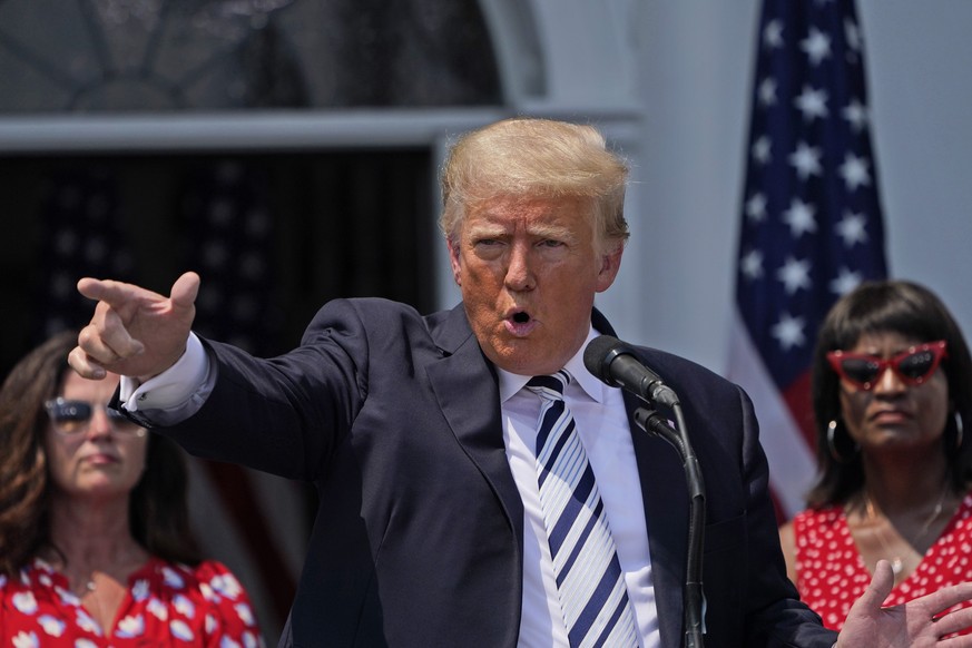 Former President Donald Trump imitates the shooting of a gun with his finger while talking about gun violence in Chicago as he speaks at Trump National Golf Club in Bedminster, N.J., Wednesday, July 7 ...