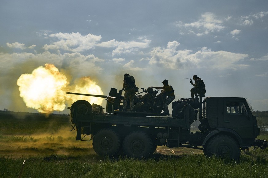 Ukrainian soldiers fire a cannon near Bakhmut, an eastern city where fierce battles against Russian forces have been taking place, in the Donetsk region, Ukraine, Monday, May 15, 2023. (AP Photo/Libko ...