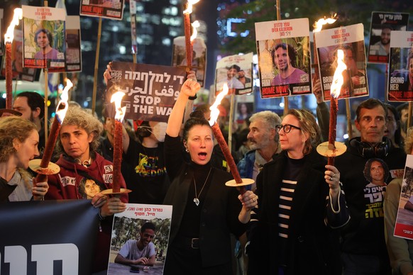 epa11826713 Famiy members of hostages held by Hamas in Gaza and their supporters light torches as they react to ceasefire reports during a protest calling for a ceasefire and for the release of the ho ...