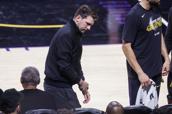 epa12948793 Los Angeles Lakers guard Luka Doncic (C) walks to the bench during the first half of the NBA Playoffs western conference semifinals game four between the Los Angeles Lakers and Oklahoma Ci ...