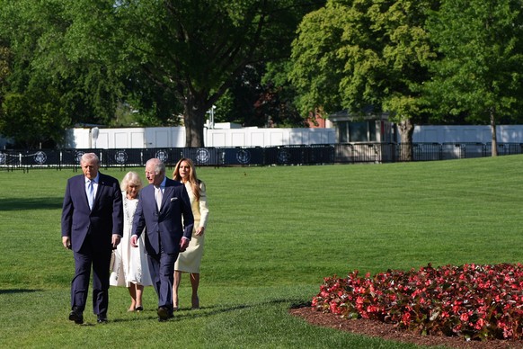 President Donald Trump and first lady Melania Trump along with Britain's King Charles III and Queen Camilla walk on the South Lawn to visit the White House garden and bee hive at the White House, ...