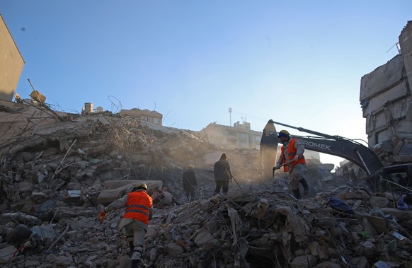 epa10464500 Search and rescue teams work at the site of collapsed buildings following a powerful earthquake in Kahramanmaras, Turkey, 13 February 2023. More than 30,000 people have died and thousands  ...