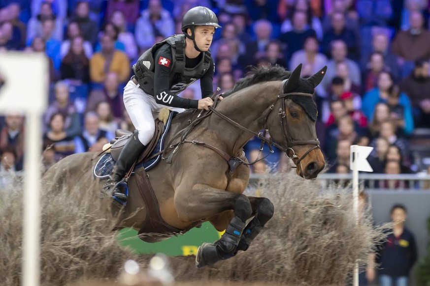 Robin Godel of Switzerland rides his horse Grandeur de Lully, during the Indoor Cross-Country at the 59th CHI international horse show jumping tournament in Geneva, Switzerland, on Friday, December 13 ...