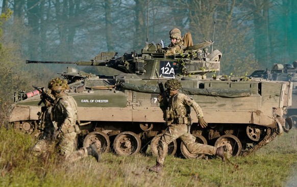 SALISBURY, ENGLAND - NOVEMBER 23: Prince William, Prince of Wales, Colonel-in-Chief, 1st Battalion Mercian Regiment (L) listens to a briefing ahead of an attack exercise during a visit to the regiment ...