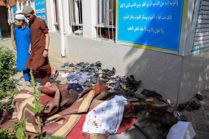 epa09976322 Shoes and blood-spattered clothes outside the Hazrat Zakaria Mosque a day after an explosion took place in its premises, in Kabul, Afghanistan, 26 May 2022. According to hospital authoriti ...