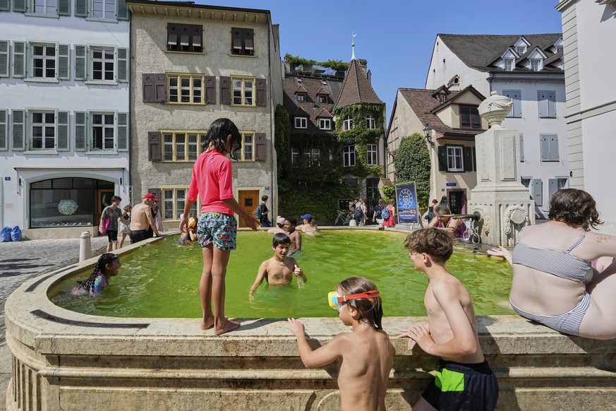 Young people take a bath at a fountain during a heat wave in the city center of Basel, Switzerland, Monday, June 30, 2025. (AP Photo/Martin Meissner)
Switzerland Extreme Weather Heat