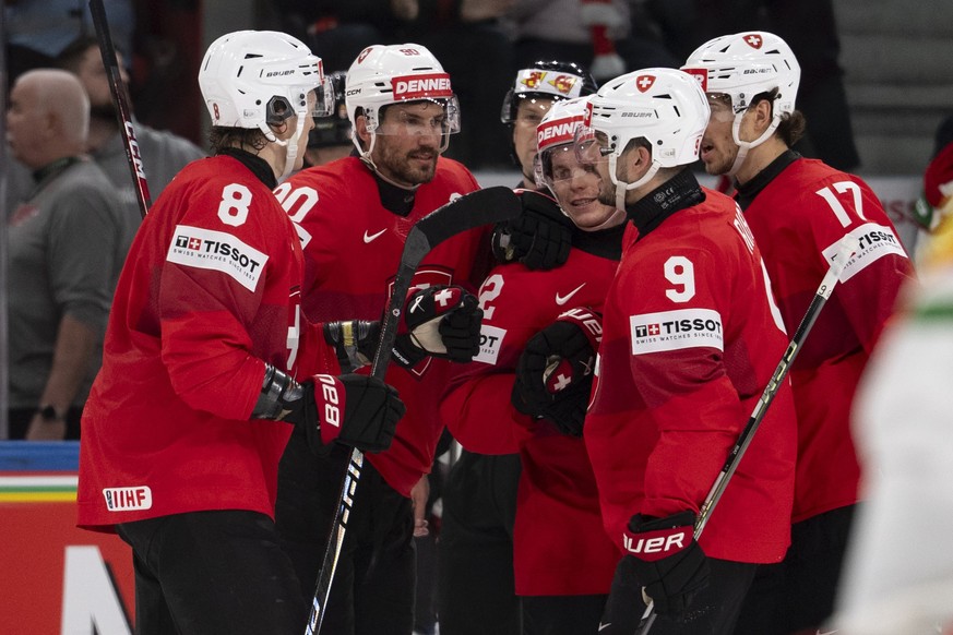 Switzerland's Roman Josi, second from left, celebrates with the team after scoring the first goalduring the 2026 IIHF Men's Ice Hockey World Championship preliminary round group A game betwe ...