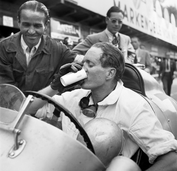 Swiss racing driver Baron Emmanuel &amp;quot;Toulo&amp;quot; de Graffenried (1914-2007) drinks to his victory at the Swiss Grand Prix near Bremgarten in the canton of Berne, Switzerland, pictured in 1 ...