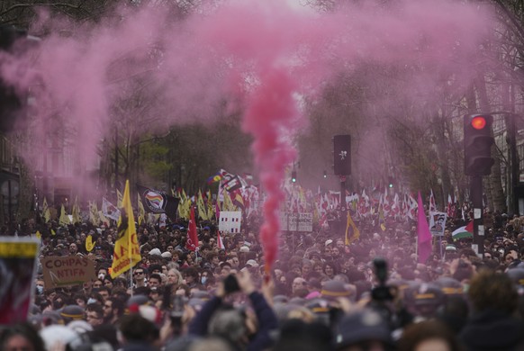 A pink smoke is fired as people march during the international day against racism and fascism, in Paris, Saturday, March 22, 2025. (AP Photo/Thibault Camus)
France Protest