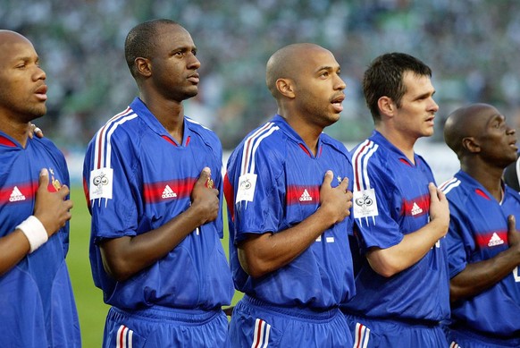 France soccer players, including Patrick Viera, second from left and Thierry Henry, third from left, sing the French national anthem before taking on Ireland in their World Cup 2006, Group 4, qualifyi ...