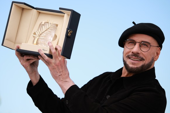 epaselect epa12963332 John Travolta poses with the Honorary Palme d'Or award during the photocall for 'Propeller One-Way Night Coach' during the 79th annual Cannes Film Festival, in Can ...