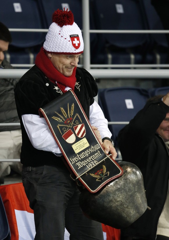 A Swiss fan rings a large bell after Switzerland defeated China during women's curling competition at the 2014 Winter Olympics, Monday, Feb. 17, 2014, in Sochi, Russia. (AP Photo/Robert F. Bukaty ...